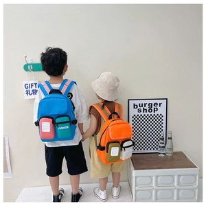 Kids wearing lightweight canvas backpacks in blue and orange colors for kindergarten