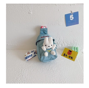 Detailed view of kids blue canvas chest bag with cute plush rabbit and HAPPY print