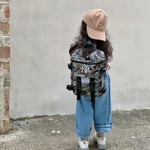 Kids lightweight camo backpack with NY embroidery shown on child model outdoors