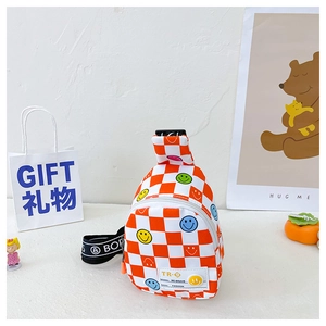 Close-up of children's orange plaid chest bag featuring colorful smiley faces and leather tag