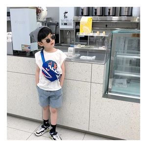 Kids streetwear outfit featuring cartoon shark crossbody bag with white vest and denim shorts