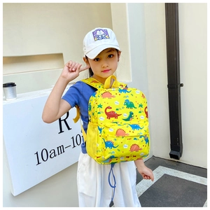 Close-up of waterproof yellow toddler backpack with colorful dinosaur prints and side mesh pocket