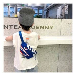 Detail of blue canvas kids chest bag featuring shark mouth print on child model