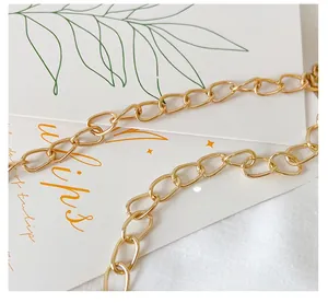 Close-up of premium gold-toned metal chain link for small crossbody girls' handbags