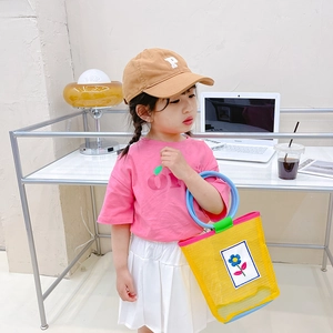 Girl's summer outfit with apple T-shirt, skirt and yellow floral mesh beach handbag