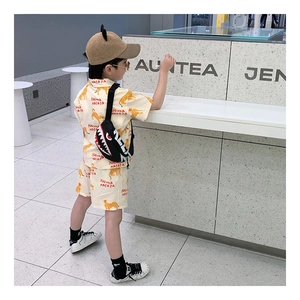 Close-up of boys shark cross-body chest bag with trendy summer safari outfit