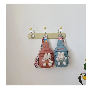 Detail of cute cartoon bunny chest bags with plush rabbits and colorful print straps
