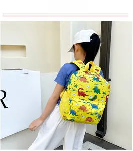 Side view of yellow toddler backpack with colorful dinosaur prints and mesh side pockets