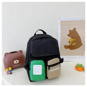Detail of kids canvas backpack showing color-block pockets and Girl Cats logo patch