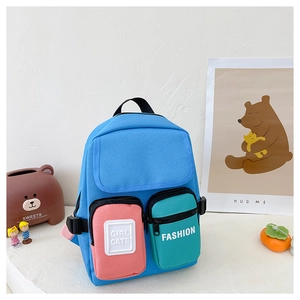 Detailed close-up of color-block canvas kids backpack with front pockets and zippers
