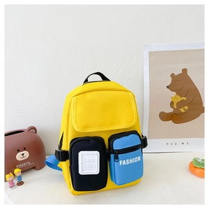 Detail view of yellow canvas toddler backpack with navy straps and colorful pockets