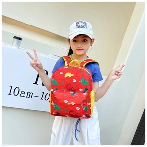 Detail showing red kids dinosaur backpack with side mesh pockets and cartoon prints