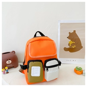 Detail view of the orange canvas kids backpack featuring functional multi-pocket design