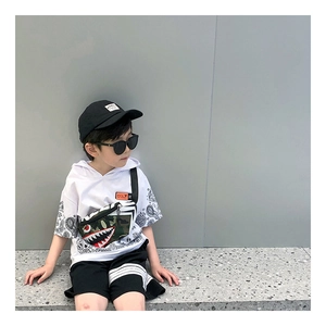 Detail of a kids camouflage chest bag with a shark face pattern for boys streetwear fashion