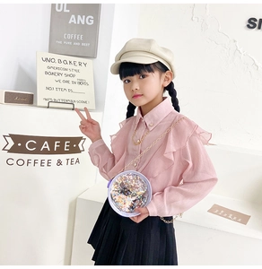 Detailed view of girl's round transparent glitter chain bag with colorful sequins