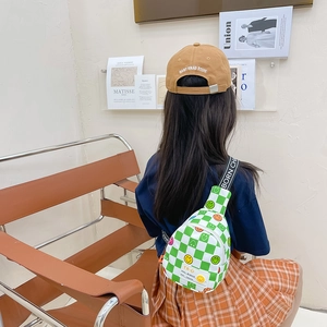 Kids green checkerboard crossbody bag with smiley face patches and camel baseball cap