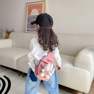 Pink kids crossbody bag featuring HAPPY embroidery and cute white plush bunny charm