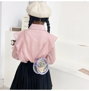 Detailed back view of a girl wearing a purple round glitter sequins crossbody bag