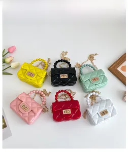Top view of mini PVC jelly bags in six colors with pearl handles and diamond quilting