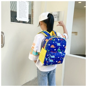 Close-up of kids dinosaur backpack featuring colorful prints and yellow mesh side pockets