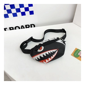 Close-up of black canvas kids chest bag featuring shark face print and adjustable strap