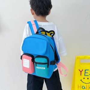 Kids lightweight canvas backpack in bright blue with pink and green pockets for ages 3-6