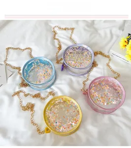 Detail of round transparent PVC bags with colorful glitters and gold chains