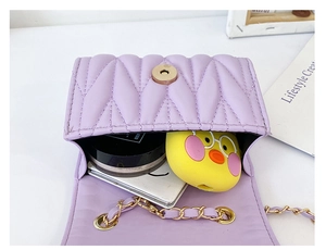Detail of light purple quilted mini bag interior with chain strap and magnetic snap