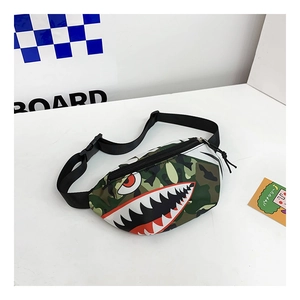 Detail of kids camo chest bag featuring a red shark mouth and adjustable black strap