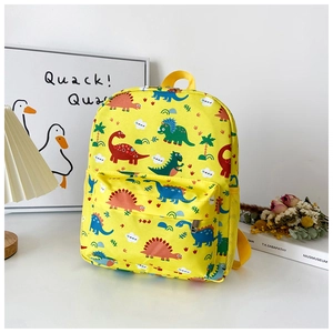 Detail of yellow canvas kids backpack featuring colorful dinosaur prints and side mesh pocket