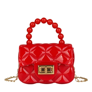 Red PVC jelly handbag with diamond lattice pattern, pearl handle, and gold chain strap