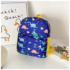 Detail of blue kids dinosaur backpack featuring colorful cartoon prints and yellow mesh pocket