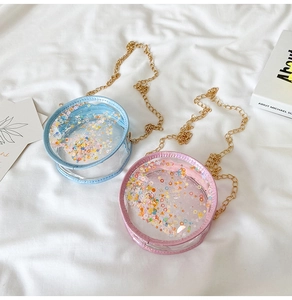 Detail of round transparent glitter bags for kids with colorful sequins and gold chain strap