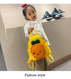 Close-up of cute 3D carrot pocket design on yellow toddler backpack for kids