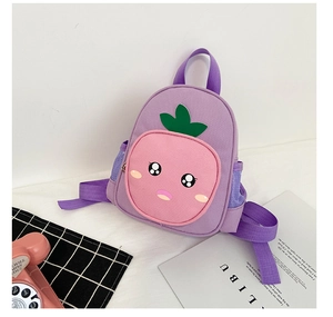 Close-up of purple strawberry kids backpack with cute cartoon eyes and mesh side pocket