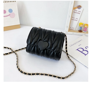 Close-up of a black quilted PU leather crossbody bag with a matte heart-shaped lock buckle
