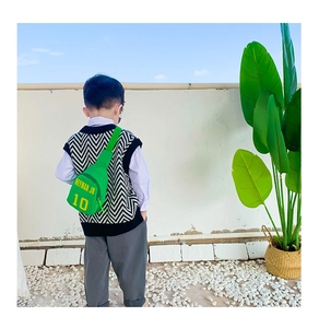 Rear view of a child wearing a vibrant green Neymar Jr crossbody sports chest bag