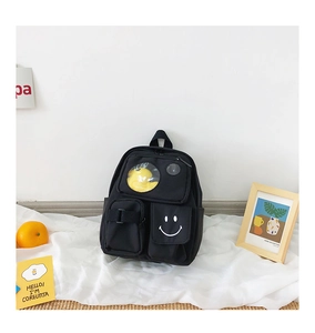 Detail of cute black canvas kids backpack with transparent window and yellow duck decor