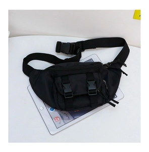 Detailed top view of a black nylon kids waist bag with multi-pocket and buckle design