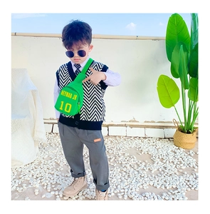 Close-up of bright green kids chest bag with yellow Neymar Jr 10 print and nylon strap