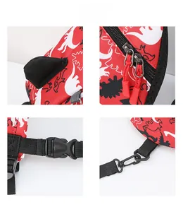 Detail view of red dinosaur backpack showing dual zippers, plastic buckle, and metal hook