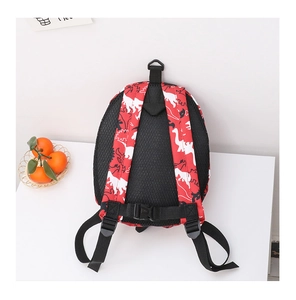 Detail of red dinosaur backpack featuring breathable mesh back and safety chest buckle