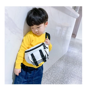 Toddler white crossbody chest bag with double buttons and mesh pocket on model