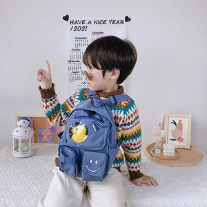 Blue kids backpack with transparent window and yellow duck toy for toddler school use
