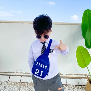 Blue kids crossbody sling bag with PIRLO 21 print worn by a young boy outdoors