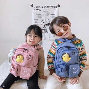 Cute toddlers wearing large capacity schoolbags with pink and blue colors and duck toys