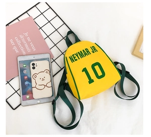 Detail of yellow canvas kids backpack featuring green Neymar Jr 10 print and strap
