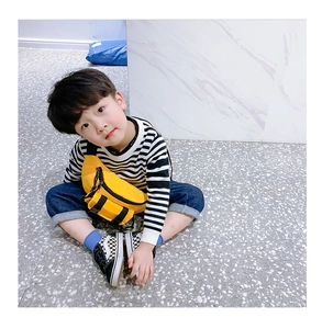 Detail of yellow nylon kids waist bag with black zipper and adjustable buckle strap