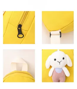Detail view of yellow canvas toddler backpack with cute plush bunny and smooth zippers