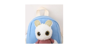 Close-up of sky blue canvas kids backpack featuring a 3D plush doll with gold sequin ears